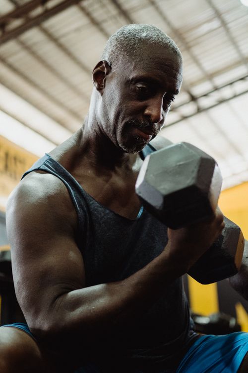 A mature adult practicing strength training with a dumbbell
